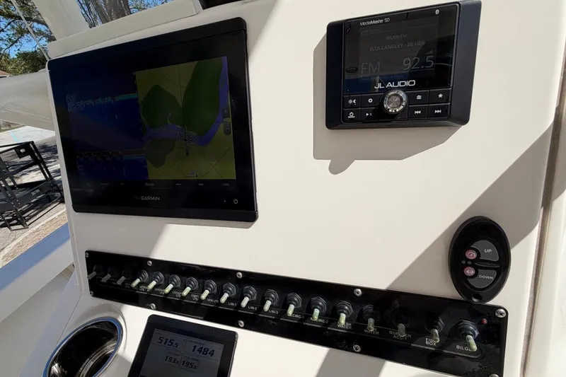 Slide: The Image of Control panel of a 2022 Pathfinder 2600 HPS boat with navigation and audio systems. - 25