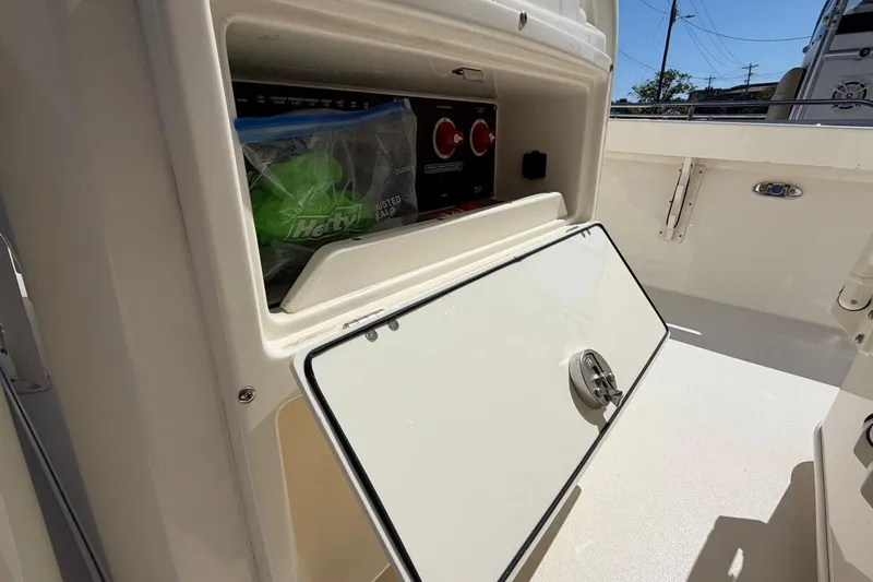 Slide: The Image of Open storage compartment on 2022 Pathfinder 2600 HPS boat, showing interior contents. - 27