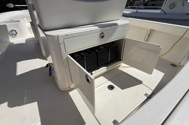 Slide: The Image of Open storage compartment on 2022 Pathfinder 2600 HPS boat, revealing battery setup. - 28