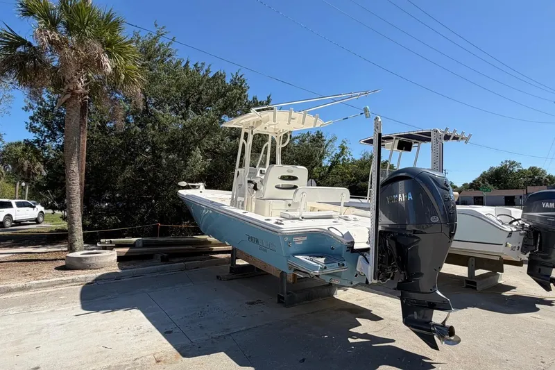 Slide: The Image of 2022 Pathfinder 2600 HPS boat with Yamaha outboard motor, parked outdoors. - 3