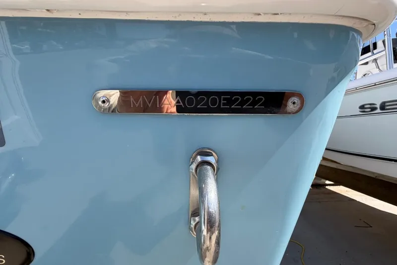 Slide: The Image of 2022 Pathfinder 2600 HPS boat with visible hull identification number on blue surface. - 6