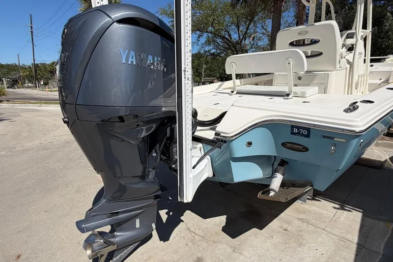Slide: The Image of 2022 Pathfinder 2600 HPS boat with Yamaha outboard motor, parked outdoors. - 7