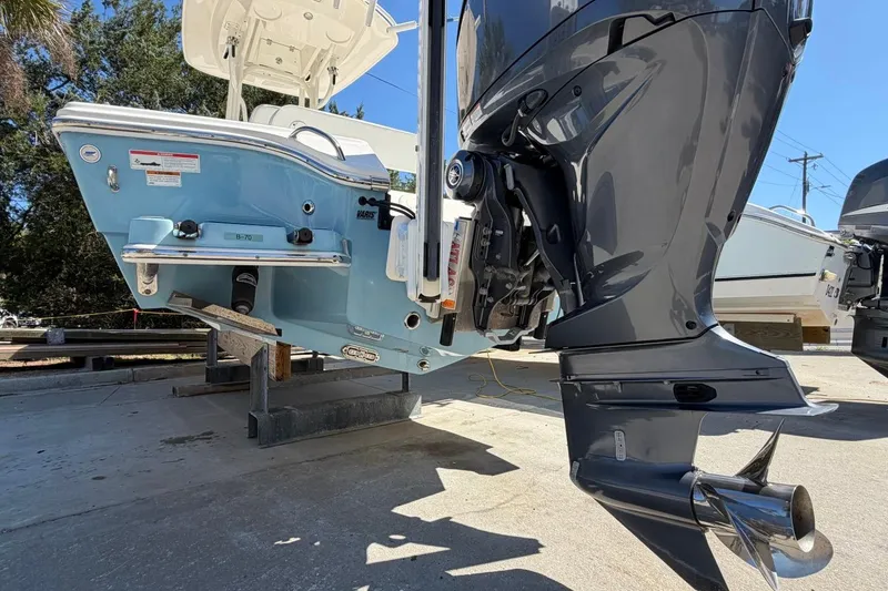 Slide: The Image of 2022 Pathfinder 2600 HPS boat with powerful outboard motor, displayed on a stand. - 9