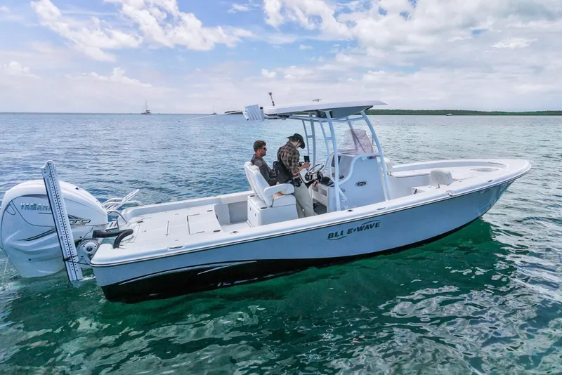 The Image of 2019 Blue Wave 2800 Pure Hybrid boat cruising on clear blue water under a partly cloudy sky. - 0