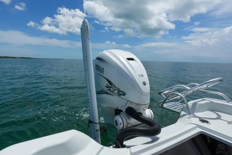 Slide: The Image of 2019 Blue Wave 2800 Pure Hybrid boat with Yamaha outboard motor on open water. - 14