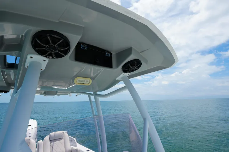 Slide: The Image of 2019 Blue Wave 2800 Pure Hybrid boat with speakers, ocean view, and clear sky. - 16