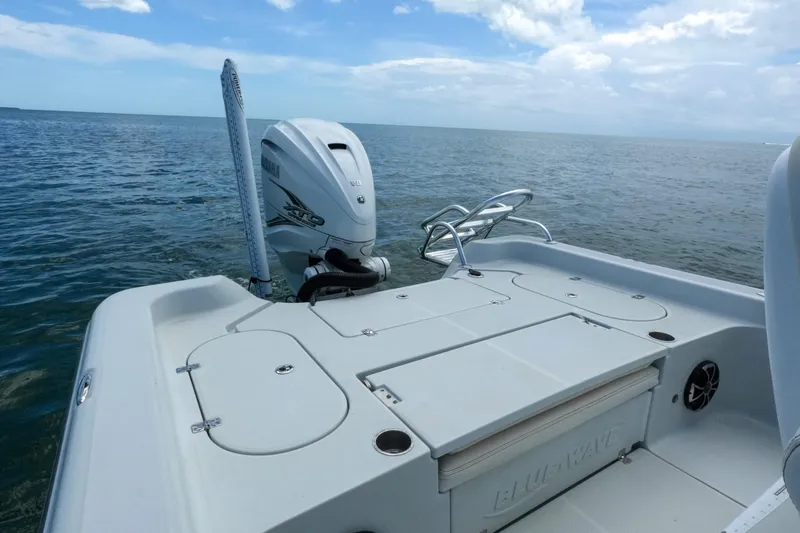 Slide: The Image of 2019 Blue Wave 2800 Pure Hybrid boat on open water, featuring Yamaha V8 engine. - 17