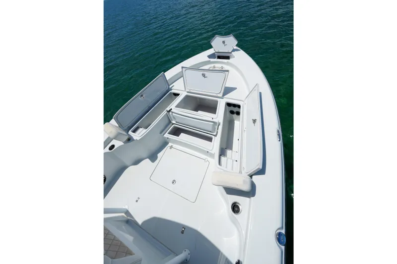 Slide: The Image of 2019 Blue Wave 2800 Pure Hybrid boat with open storage compartments on calm water. - 19
