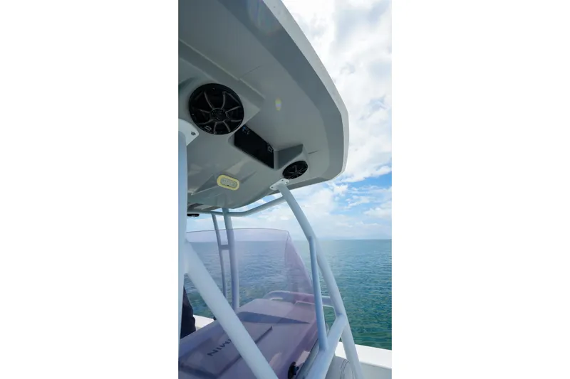 Slide: The Image of 2019 Blue Wave 2800 Pure Hybrid boat with speakers, ocean view, and clear sky. - 25