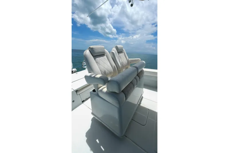 Slide: The Image of Luxurious seating on 2019 Blue Wave 2800 Pure Hybrid boat under a clear blue sky. - 27