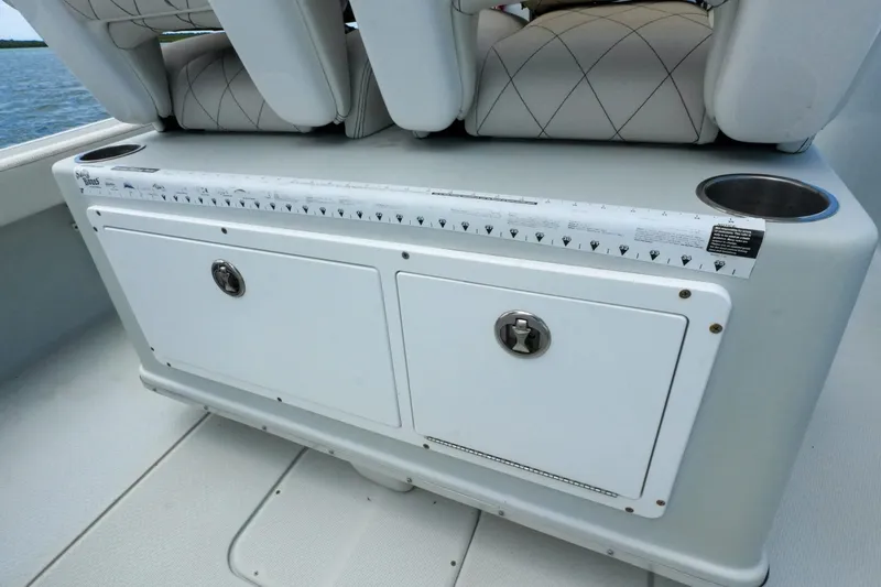 Slide: The Image of 2019 Blue Wave 2800 Pure Hybrid boat storage compartment with cushioned seating and cup holders. - 30
