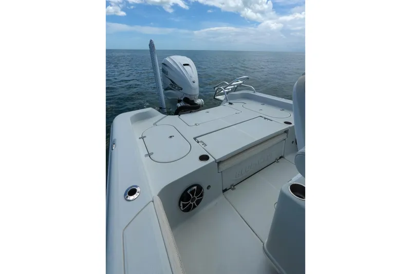 Slide: The Image of 2019 Blue Wave 2800 Pure Hybrid boat on open water, showcasing deck and motor. - 31