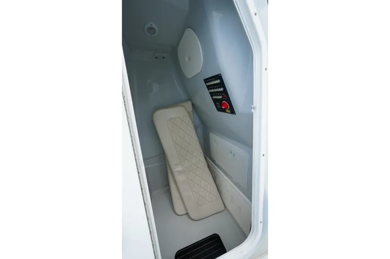 Slide: The Image of Interior cabin of 2019 Blue Wave 2800 Pure Hybrid boat, featuring a cushioned seat and control panel. - 32