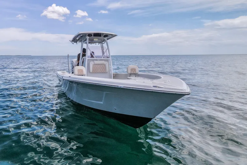 Slide: The Image of 2019 Blue Wave 2800 Pure Hybrid boat on calm ocean waters under a clear sky. - 4