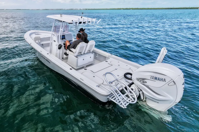 Slide: The Image of 2019 Blue Wave 2800 Pure Hybrid boat on open water, featuring Yamaha engine. - 5