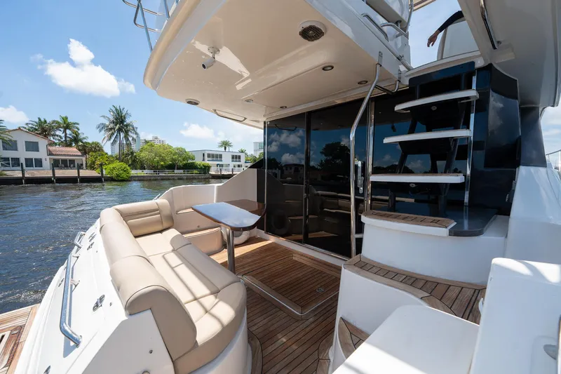 Slide: The Image of 2016 Sea Ray 510 Fly yacht with outdoor seating and staircase. - 12