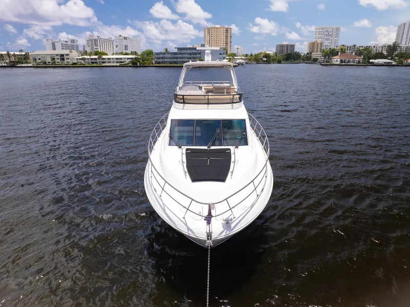 Slide: The Image of 2016 Sea Ray 510 Fly yacht on water with city skyline background. - 2