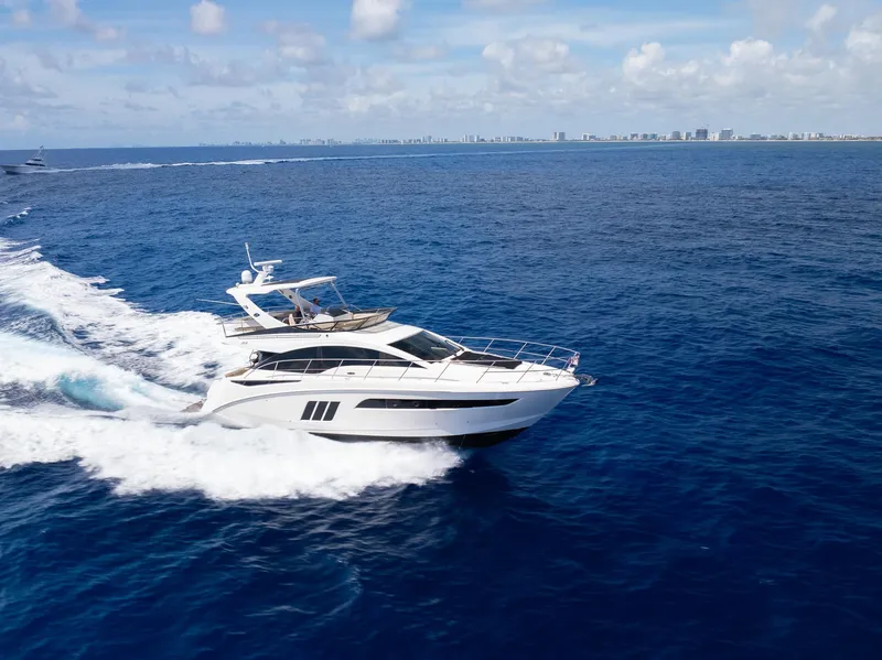 Slide: The Image of 2016 Sea Ray 510 Fly yacht cruising on open water. - 38