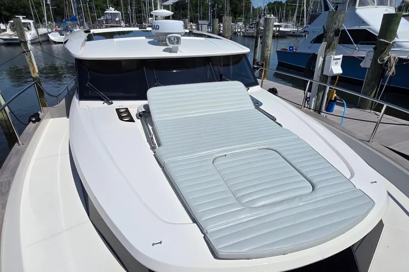 Slide: The Image of 2023 Greenline 40 yacht with sunbed on deck, docked at marina. - 9