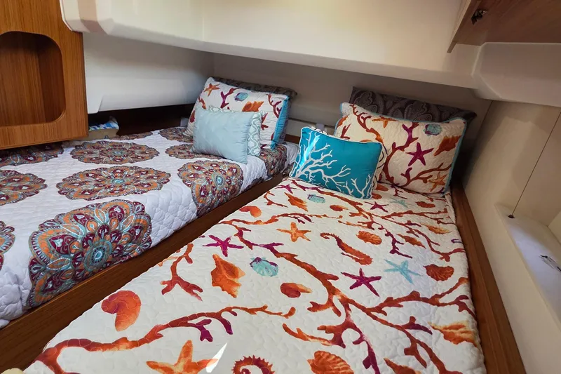 Slide: The Image of Cozy cabin interior of 2023 Greenline 40 yacht with vibrant bedding and pillows. - 35