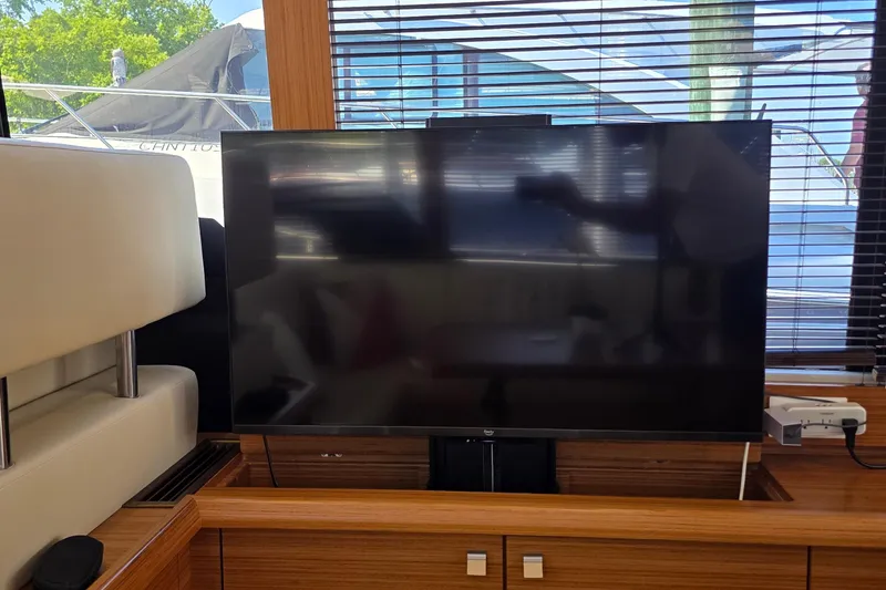 Slide: The Image of Interior of 2023 Greenline 40 yacht featuring a modern flat-screen TV setup. - 24