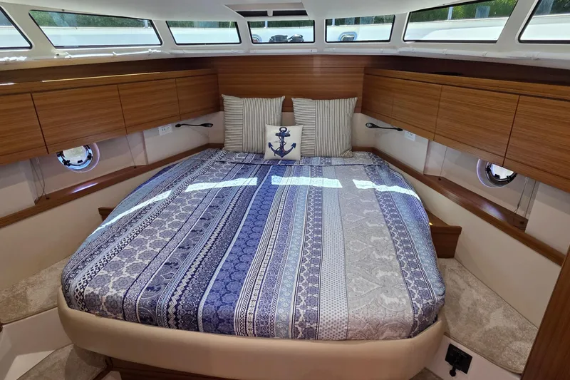 Slide: The Image of Luxurious cabin interior of 2023 Greenline 40 yacht with stylish bedding and wood accents. - 36