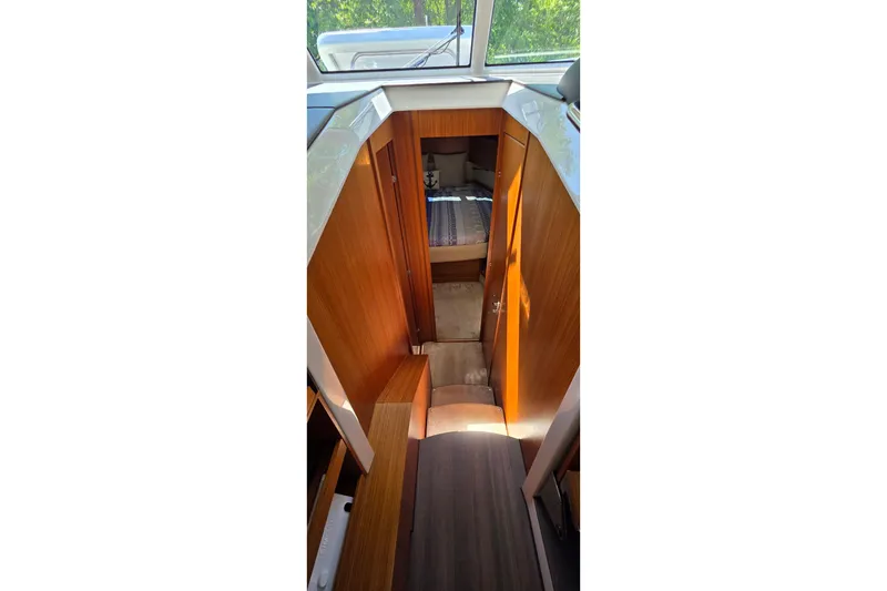 Slide: The Image of Interior view of 2023 Greenline 40 yacht cabin with wooden finishes. - 32