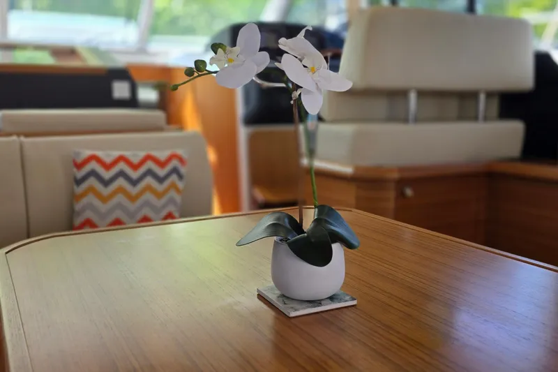 Slide: The Image of Elegant interior of 2023 Greenline 40 yacht with orchid centerpiece on wooden table. - 22