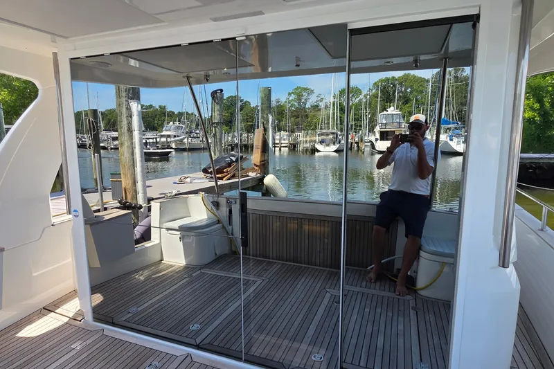 Slide: The Image of 2023 Greenline 40 yacht interior with mirrored doors, docked at a marina. - 13
