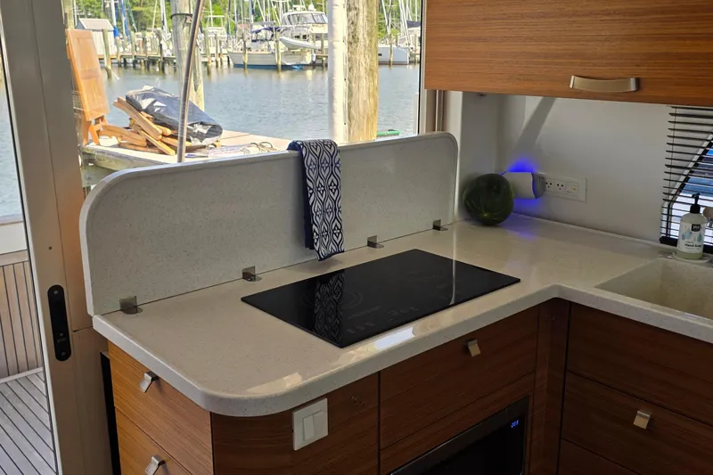 Slide: The Image of Modern kitchen in 2023 Greenline 40 yacht with sleek countertop and induction cooktop. - 18