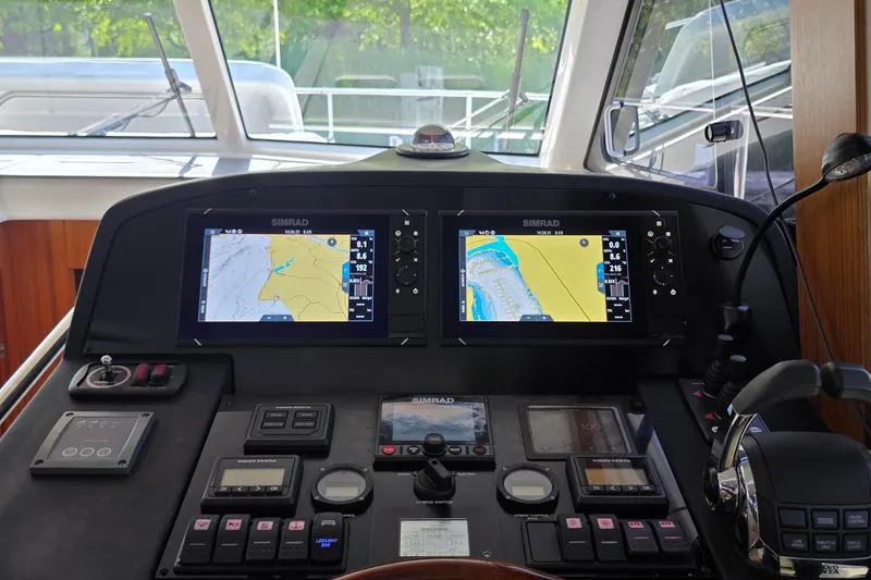 Slide: The Image of Helm of 2023 Greenline 40 yacht with dual Simrad navigation displays. - 31