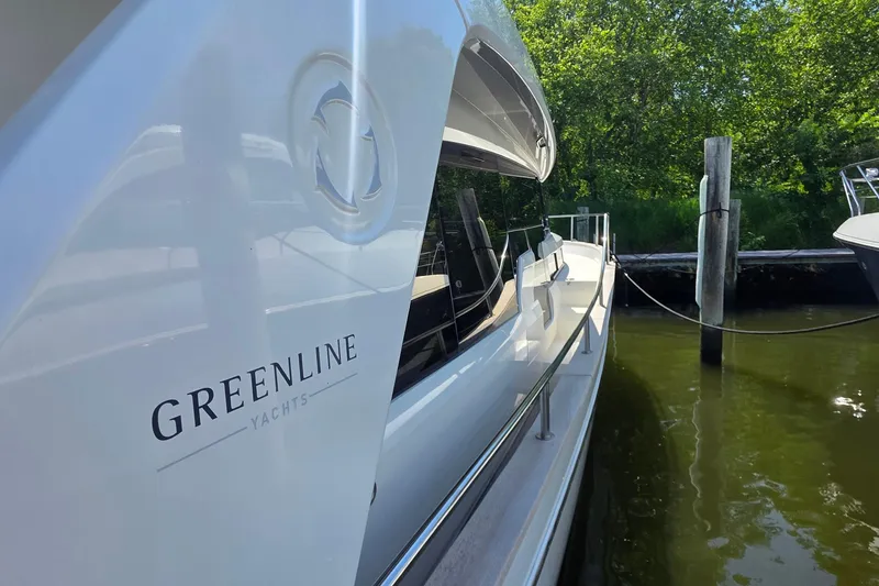 Slide: The Image of 2023 Greenline 40 yacht docked, showcasing sleek design and branding. - 7