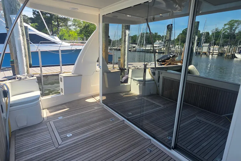 Slide: The Image of 2023 Greenline 40 yacht deck with glass doors and marina view. - 5