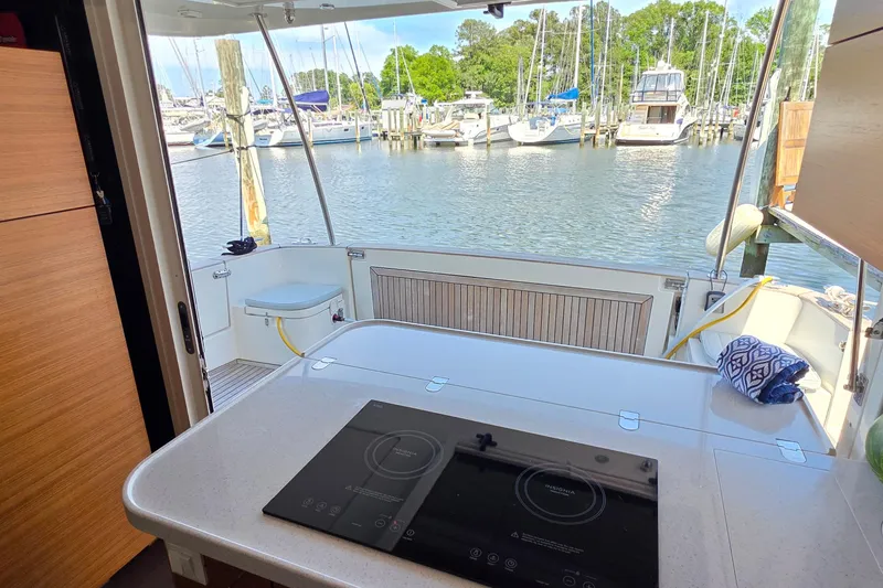 Slide: The Image of Interior view of 2023 Greenline 40 yacht with marina backdrop. - 15