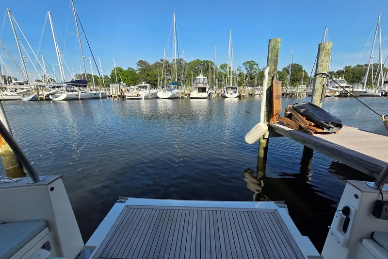 Slide: The Image of Marina view from a 2023 Greenline 40 yacht, showcasing sailboats and clear blue skies. - 47