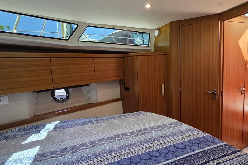Slide: The Image of Luxurious cabin interior of 2023 Greenline 40 yacht with wood paneling and patterned bedding. - 38