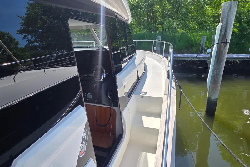 Slide: The Image of 2023 Greenline 40 yacht docked, showcasing sleek design and modern features. - 8