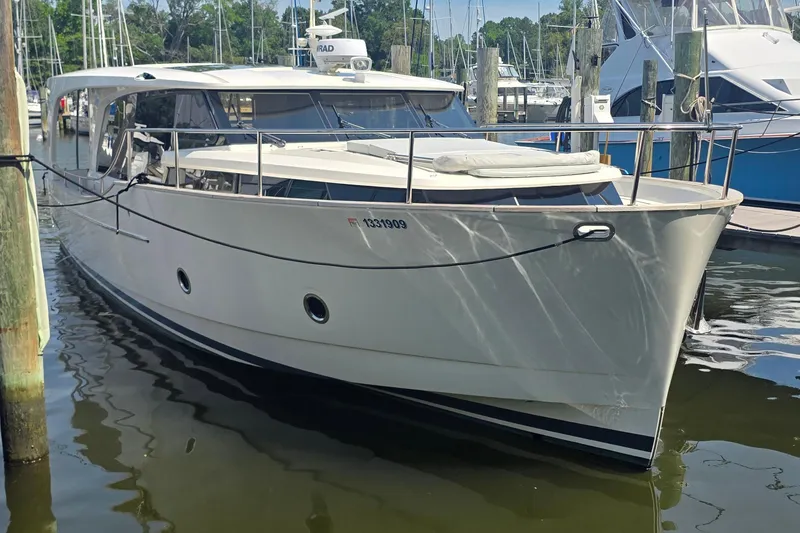 Slide: The Image of 2023 Greenline 40 yacht docked at marina, showcasing sleek design and modern features. - 2