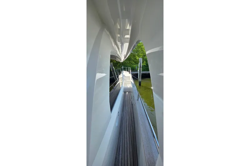 Slide: The Image of Side view of 2023 Greenline 40 yacht, showcasing sleek design and wooden deck. - 6