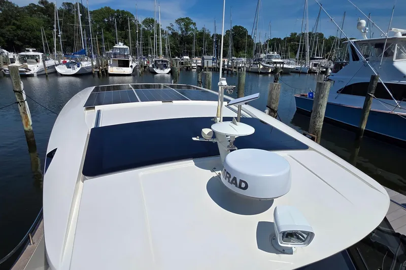 Slide: The Image of 2023 Greenline 40 yacht with solar panels docked at a marina. - 10
