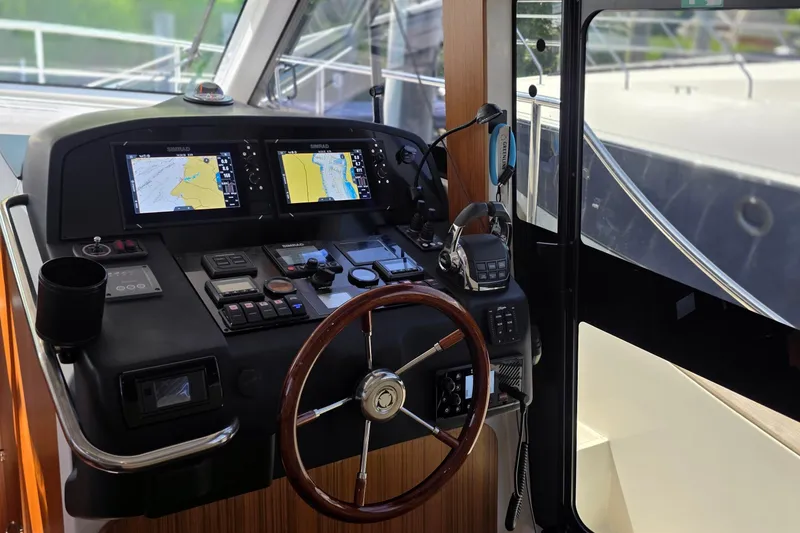 Slide: The Image of Cockpit of 2023 Greenline 40 yacht with navigation screens and steering wheel. - 28