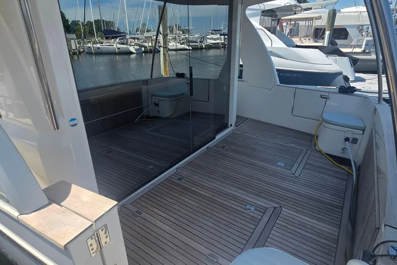 Slide: The Image of 2023 Greenline 40 yacht with spacious teak deck at marina. - 4