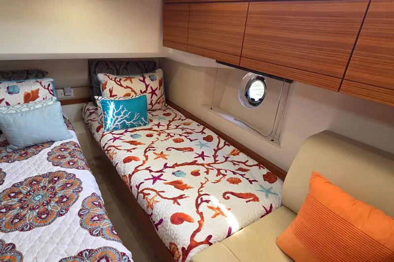 Slide: The Image of Cozy cabin interior of 2023 Greenline 40 yacht with vibrant bedding and wooden cabinets. - 34