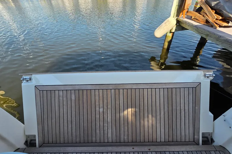 Slide: The Image of 2023 Greenline 40 yacht swim platform by the water, dockside view. - 46