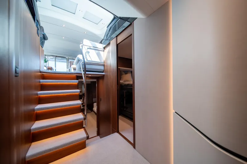 Slide: The Image of Interior of 2023 Princess S66 Sportbridge yacht with modern staircase and elegant design. - 17