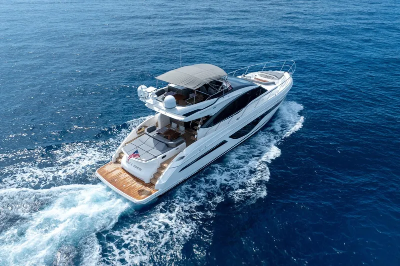 Slide: The Image of 2023 Princess S66 Sportbridge yacht cruising on open blue sea. - 1