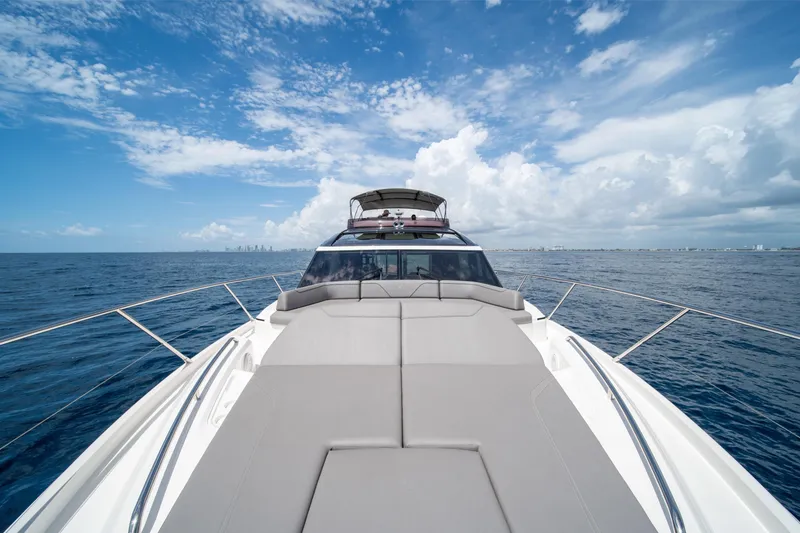 Slide: The Image of 2023 Princess S66 Sportbridge yacht cruising on open ocean under blue sky. - 33