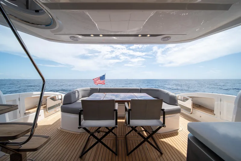 Slide: The Image of Luxurious 2023 Princess S66 Sportbridge yacht deck with ocean view and seating area. - 5