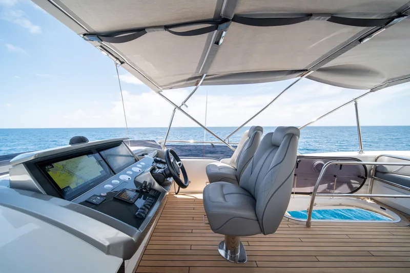 Slide: The Image of Luxurious 2023 Princess S66 Sportbridge yacht helm with ocean view and modern navigation system. - 30