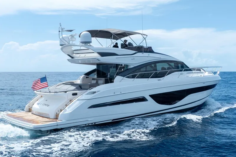 Slide: The Image of 2023 Princess S66 Sportbridge yacht cruising on open sea with American flag. - 35